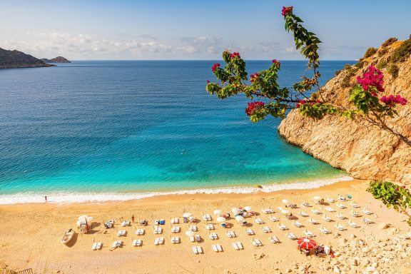 Kaputas beach in Antalya region, Turkey with clear turquoise water, sun umbrellas and sandy beach. Holiday or vacation resort