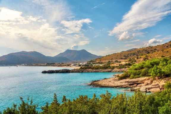 Rocky shoreline and village backdrop of Palamutbükü on the Datça Peninsula